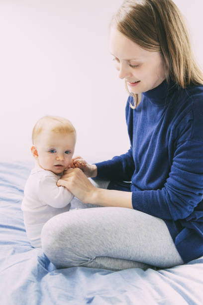 istock Mother playing with adorable baby 1221822500