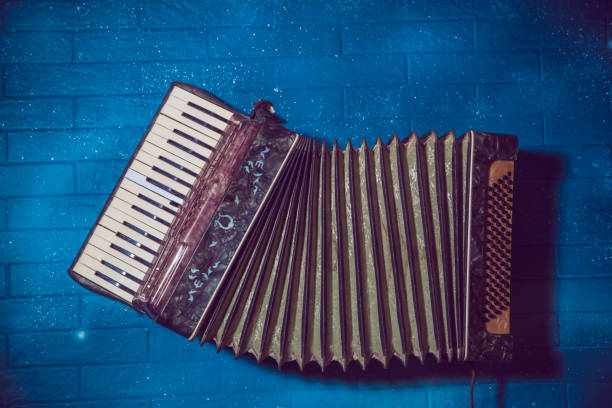 Old musical accordion isolated on dark background. Accordion in close up. Musical instrument of the harmonic family. Musical equipment. Accordion for music students.