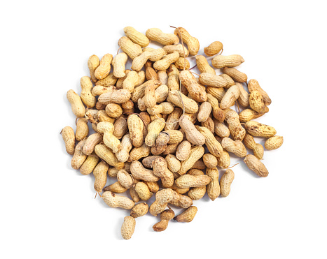 Round shaped Inshell peanuts heap on white background