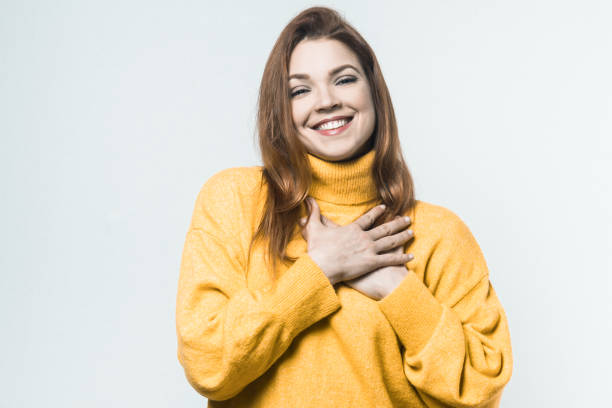 istock Cheerful young woman with hands on chest 1221824656