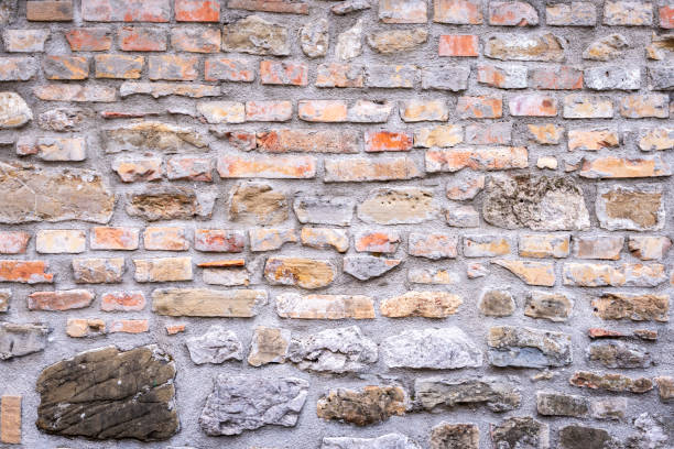 A very old weathered stone brick wall as a background
