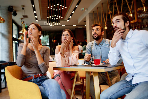 Group of friends watching game in cafe stock photo