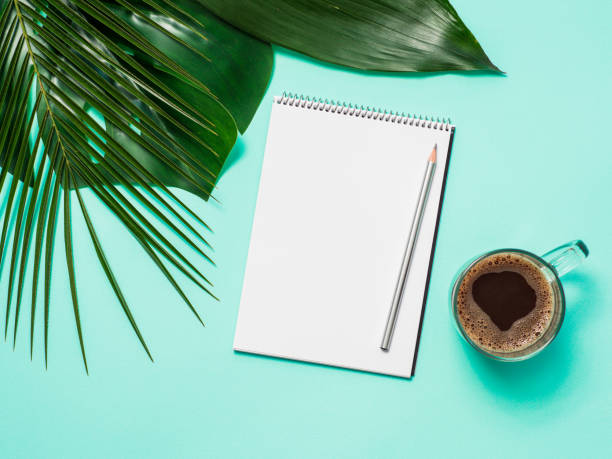 istock Blank paper notebook and tropical leaves 1221830804
