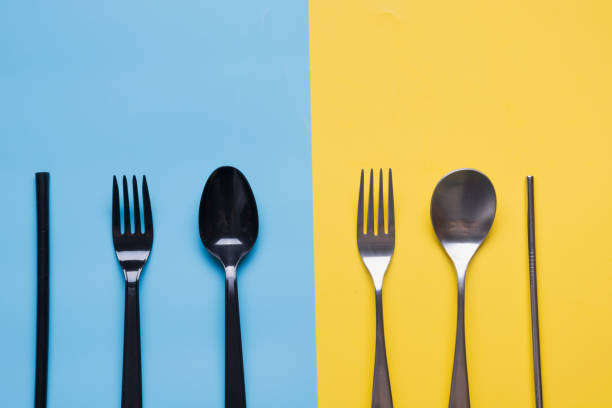 istock Comparison of metal silverware and plastic cutlery. View from above. Zero waste. Danger of plastic, but virus safe. 1221831998