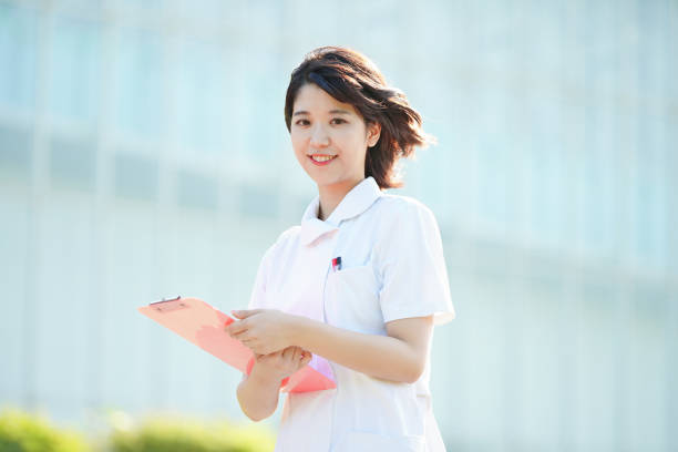 istock Asian young female nurse outdoors 1221832019