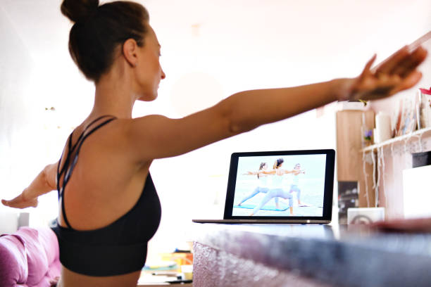 istock Woman watching on-line video training repeat asanas 1221832669