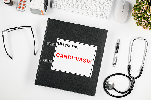 .Doctor's workspace, in the center is a folder with the inscription: candidiasis