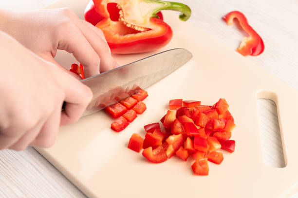 istock A section of bell pepper with a sharp knife on a cutting board made of artificial stone 1221832803