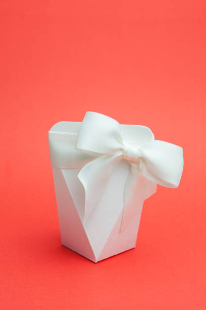 istock diamond shaped box with ribbon on red 1221833426