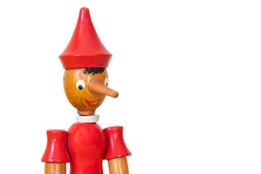 Close Up Head Shot Of A Wooden Pinocchio Toy, Isolated On White Background