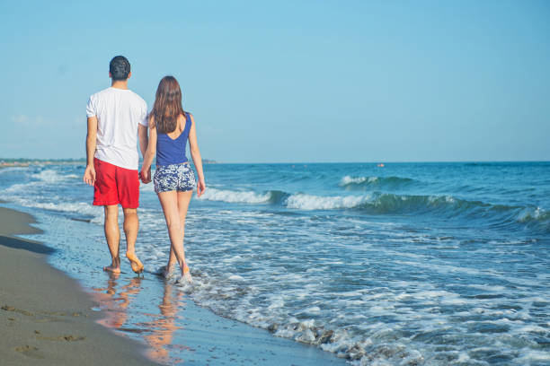 istock Happy young couple having fun at beach on sunny day 1221833992
