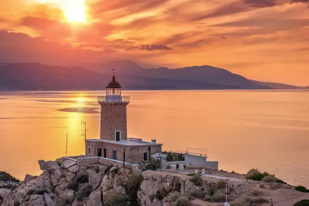.Beautiful sunset in the lighthouse in Melagavi cape at Loutraki, Greece.