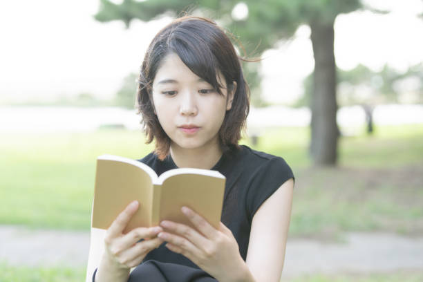 istock female college student reading book 1221834371