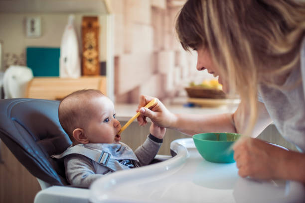 istock Mom feeding her son at home 1221835034