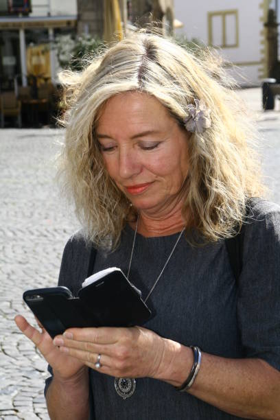 istock attractive woman with cellphone, reading and writing, 1221835424