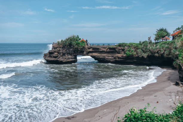 istock large waves crashing into large rocks 1221835654