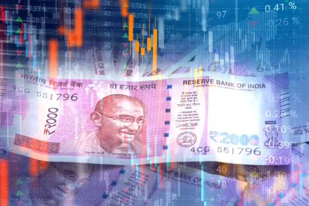 Indian Rupee paper currency on virtual interface of stock market data