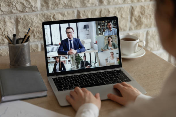 istock Male employee talk on video call with diverse colleagues 1221837408