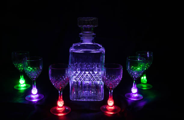 istock Liquor bottle with lighted glass goblets 1221837836