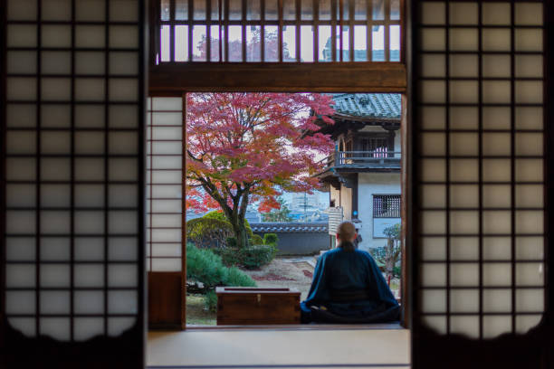 Buddhist monks performing zen at autumn temple