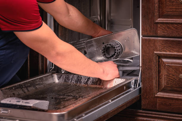 istock Young Male Technician Repairing Dishwasher In Kitchen 1221839204