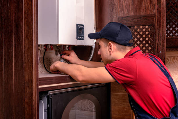 istock Plumber adjusts gas boiler before operating 1221839215