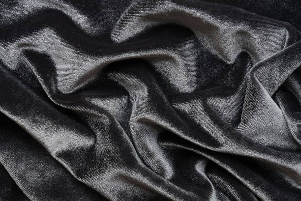 istock velvet texture dark grey black color background, expensive luxury fabric,  wallpaper. copy space 1221840601