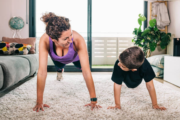 istock Mother and son doing exercise at home 1221842902