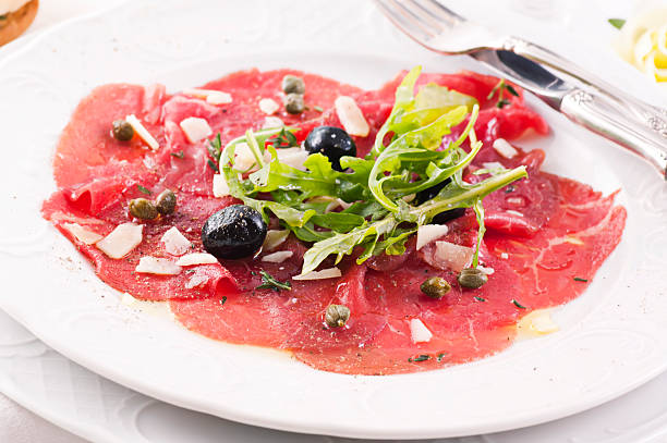 Carpaccio with olives and Parmesan stock photo