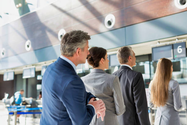 istock Business people queueing for check in at airport 1221843955