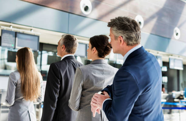 istock Business people queueing for check in at airport 1221844208