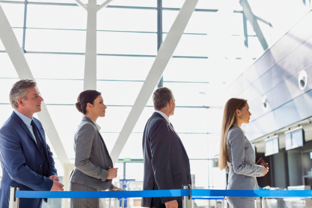istock Business people queueing for check in at airport 1221844365