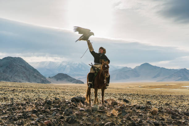 istock Eagle hunter on horse in desert in Mongolia 1221845471