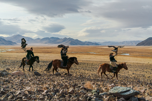 Portrait of group of eagle hunters in Mongolia  on the background of river