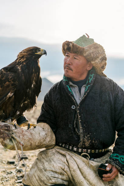 istock Portrait of eagle hunter in desert   in Mongolia 1221845627