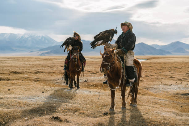 istock Portrait of two eagle hunters near the river in Mongolia 1221845675
