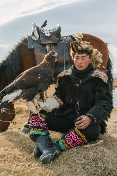 istock Portrait of eagle hunter near the river  in Mongolia 1221845701