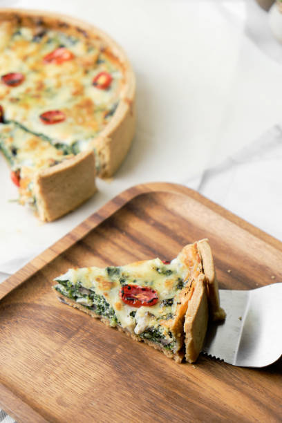 istock Homemade cheesy spinach quiche for brunch. set on white cafe table background. 1221845873