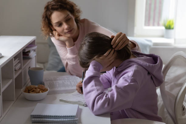 Loving mother supporting tired teenage daughter having difficulty with education Loving mother supporting tired teenage daughter study together at home. Worried young parent mom helping comforting sad teen encouraging school girl having difficulty with education learning at home. woman comforting depressed friend stock pictures, royalty-free photos & images