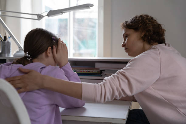 Worried mother talking comforting upset teen daughter at home Worried young mother talking comforting upset teen daughter helping with problem or apologizing at home. Caring parent mum consoling depressed adolescent child giving psychological support concept. woman comforting depressed friend stock pictures, royalty-free photos & images