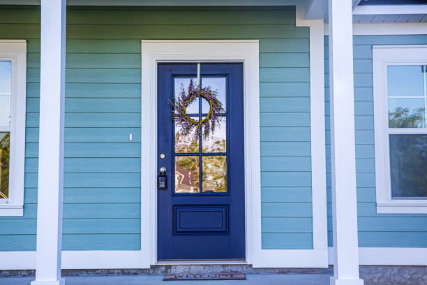 Blue Front Door of a brand new construction house with blue siding, a  ranch style home with a yard Blue front door of a brand new construction house with blue siding, a  ranch style home with a yard front stoop photos stock pictures, royalty-free photos & images
