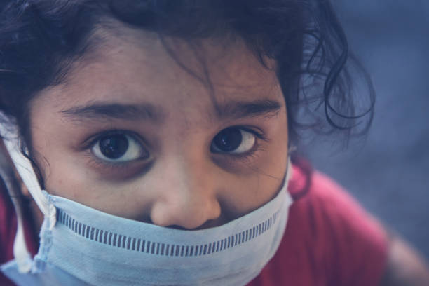 Corona virus COVID-19 epidemic outbreak quarantine concept of cute sick little girl wearing protection medical mask Corona virus COVID-19 epidemic outbreak quarantine concept of cute sick little girl wearing protection medical mask curfew stock pictures, royalty-free photos & images