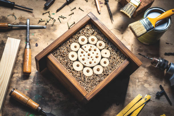 istock Handmade insect hotel or house on wooden table at workshop 1221847979