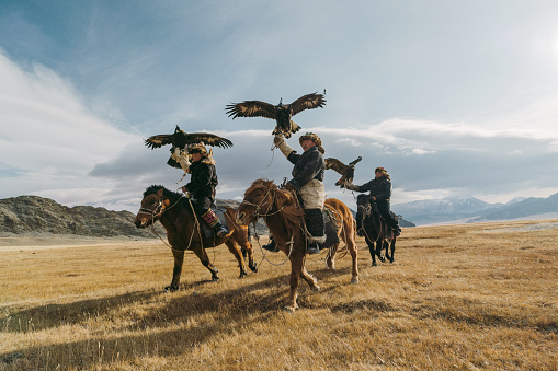 Portrait of group of eagle hunters near the river in Mongolia