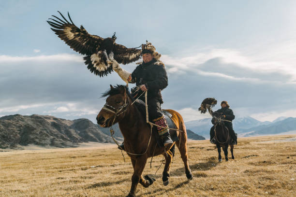 istock Portrait of two eagle hunters near the river in Mongolia 1221850806
