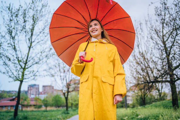 istock Smiling woman with red umbrella 1221851124