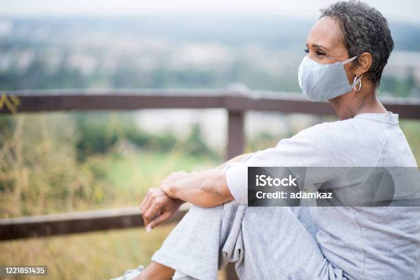Beautiful African American Woman Senior Portrait Wearing Mask Stock Photo - Download Image Now