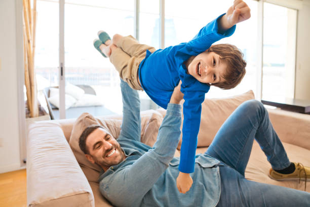 Excited father and son enjoying time together during lockdown