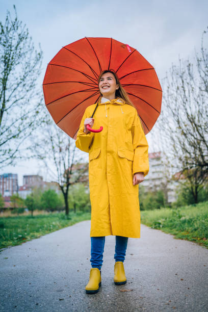 istock Smiling woman with red umbrella 1221852282