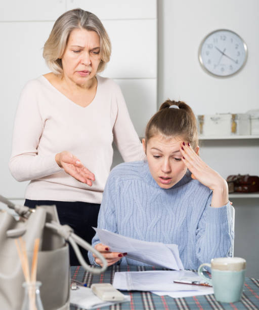 istock Woman quarreling with mother for documents 1221852368